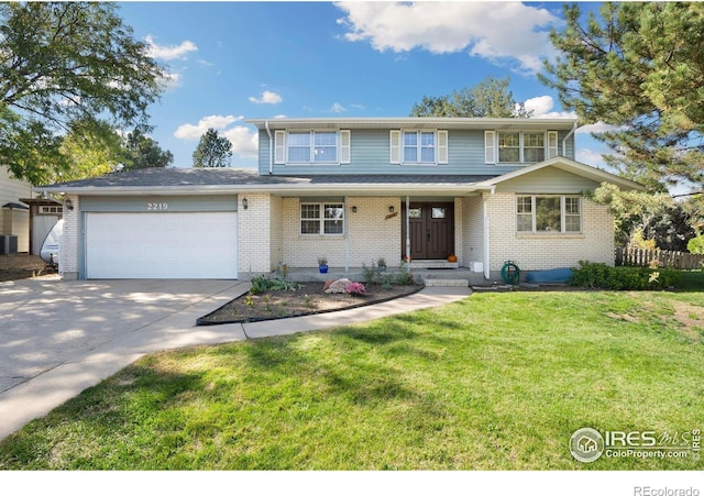 view of front of property with a garage, central AC unit, and a front lawn