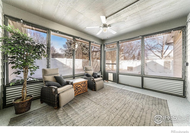 sunroom / solarium featuring ceiling fan