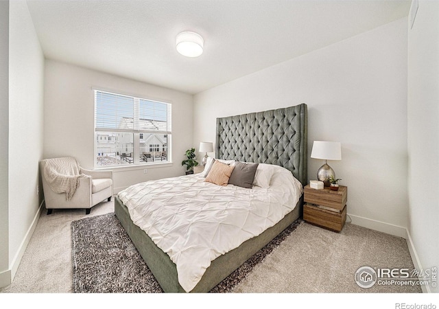 bedroom featuring light carpet