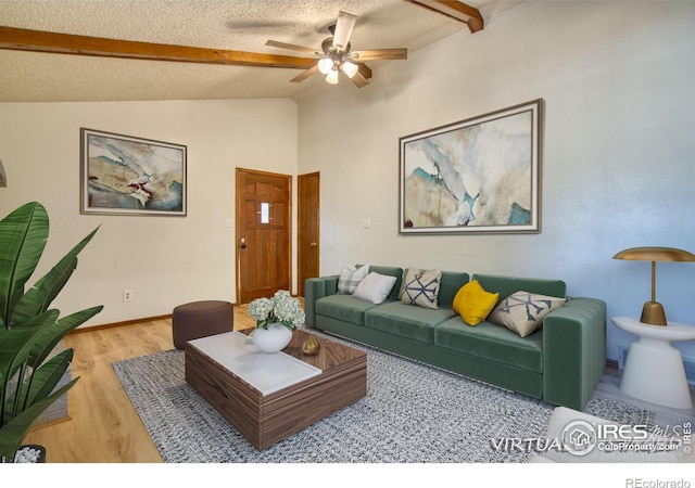 living room with vaulted ceiling with beams, wood-type flooring, a textured ceiling, and ceiling fan