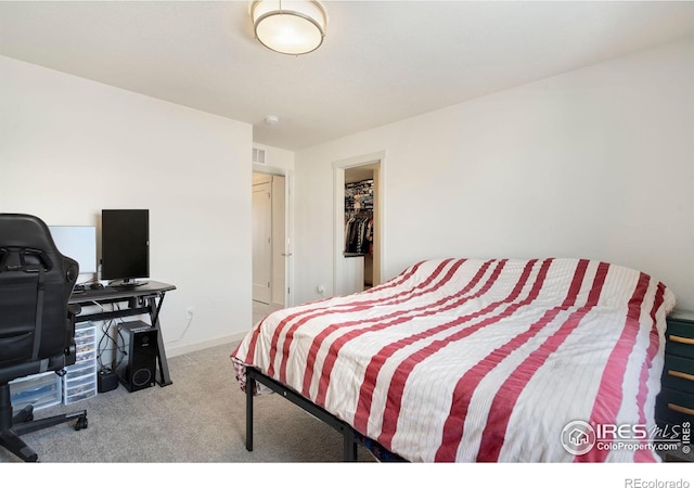 bedroom featuring light carpet and a closet