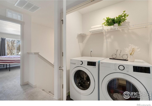 washroom with carpet floors and washing machine and clothes dryer