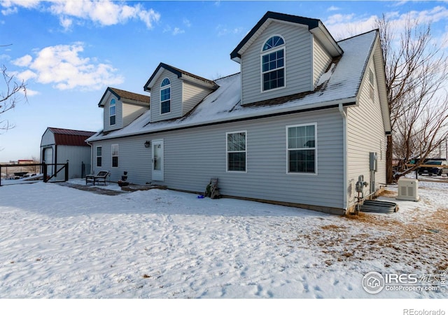 snow covered property with an outdoor structure