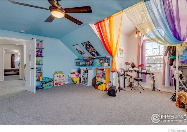 rec room featuring lofted ceiling, ceiling fan, and carpet flooring