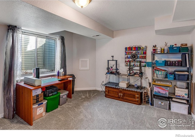 office featuring carpet, visible vents, baseboards, and a textured ceiling