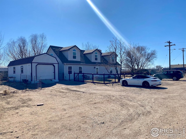 view of front of home with fence and an attached garage