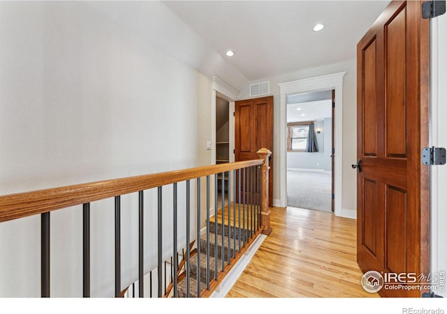 hallway with light hardwood / wood-style floors