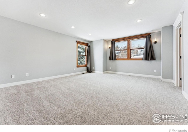 spare room featuring light colored carpet