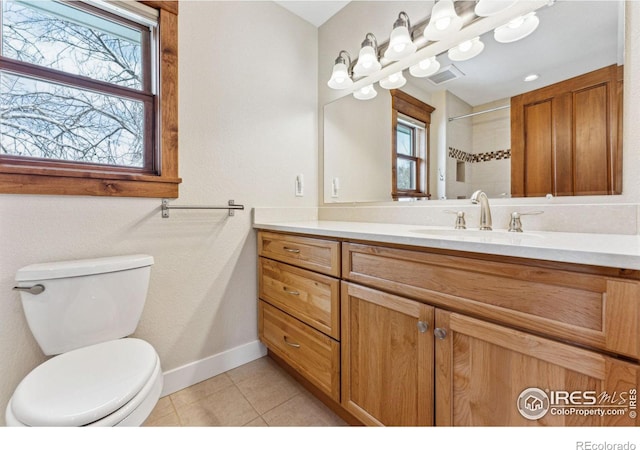 bathroom with tile patterned flooring, vanity, and toilet