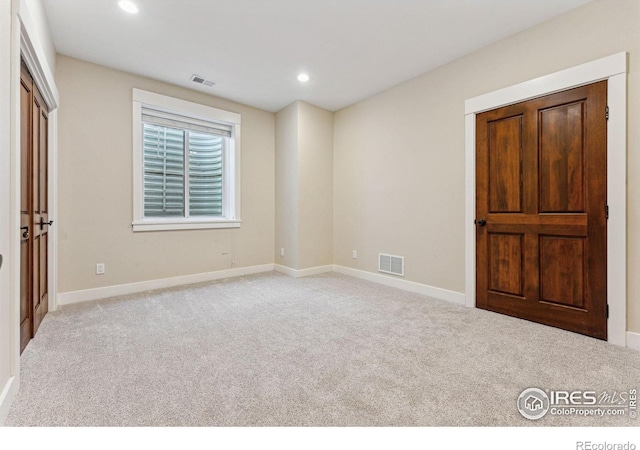 unfurnished bedroom featuring light colored carpet