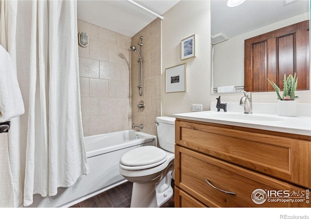 full bathroom with vanity, toilet, hardwood / wood-style floors, and shower / bath combo with shower curtain