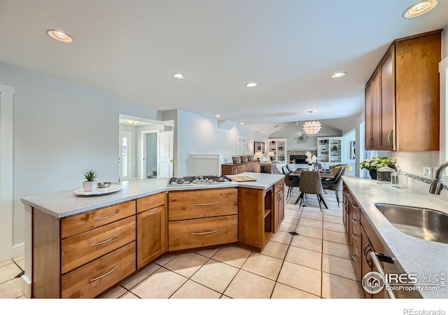 kitchen featuring sink, vaulted ceiling, stainless steel gas cooktop, and light tile patterned flooring