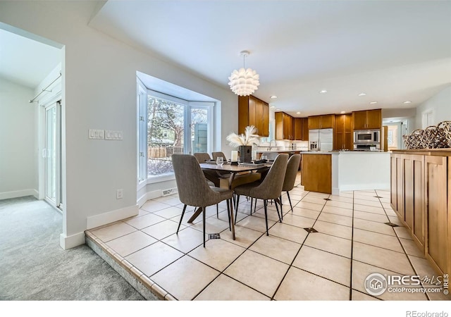 dining space with light tile patterned floors and a notable chandelier