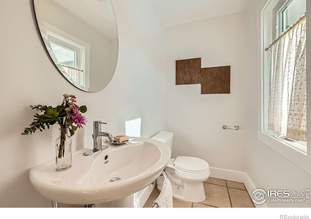 bathroom featuring tile patterned floors, toilet, and sink