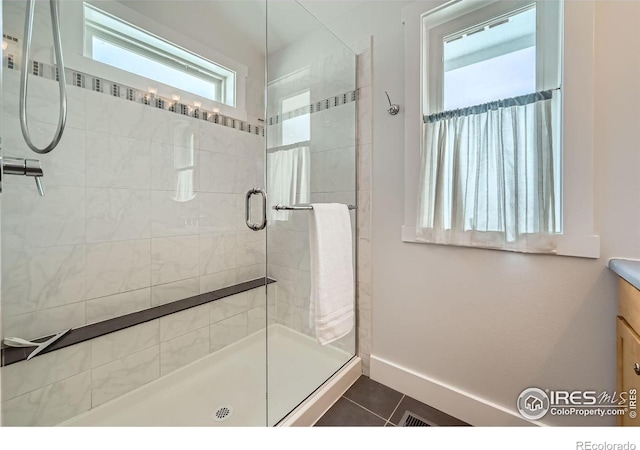 bathroom featuring tile patterned floors and an enclosed shower