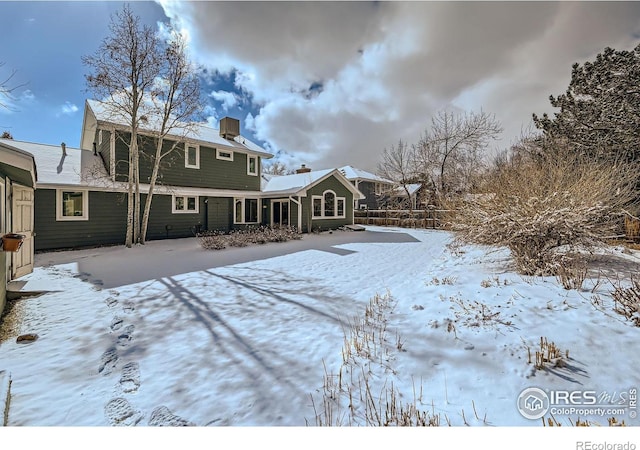 view of snow covered house