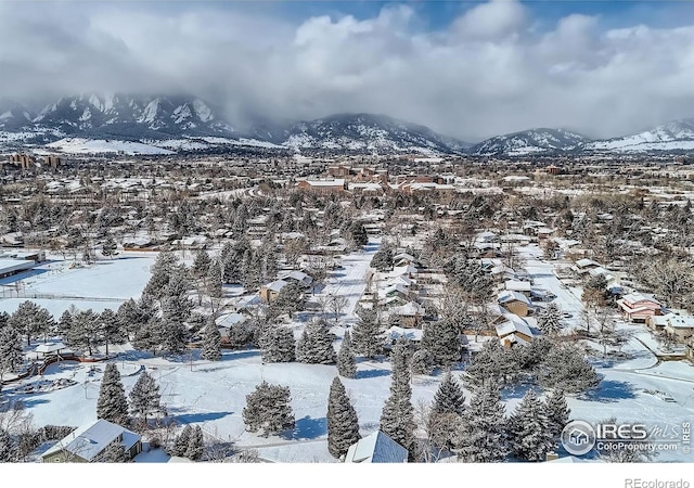 snowy aerial view with a mountain view