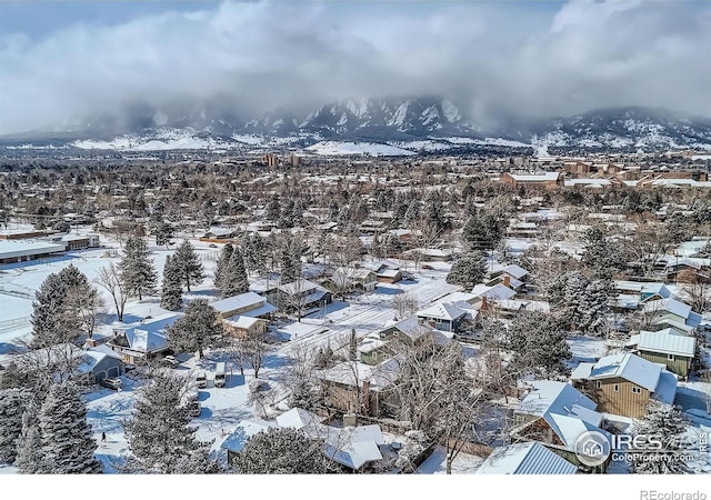 snowy aerial view with a mountain view