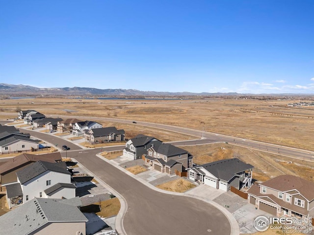 birds eye view of property with a mountain view