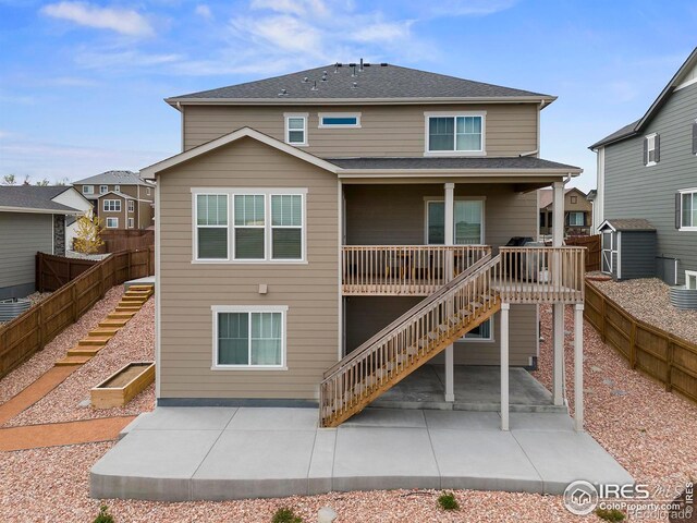5966 Indian Wells Ct, Windsor, CO 80528 - rear view of property featuring stairs, a patio, and a shed