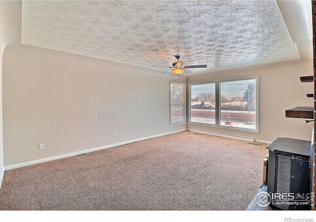 unfurnished living room with ceiling fan, carpet, and a textured ceiling