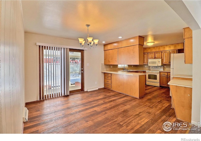 kitchen featuring decorative light fixtures, a chandelier, dark hardwood / wood-style flooring, kitchen peninsula, and white appliances