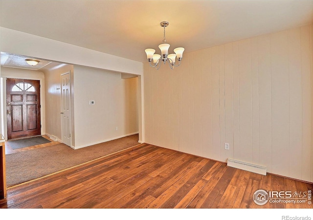 unfurnished room with dark hardwood / wood-style floors and a notable chandelier