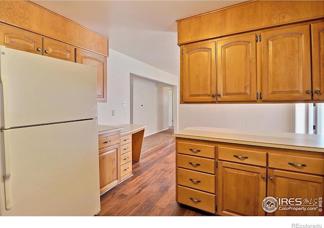 kitchen with white fridge and dark hardwood / wood-style floors