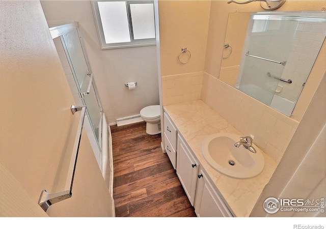 bathroom featuring vanity, a shower with door, and hardwood / wood-style floors