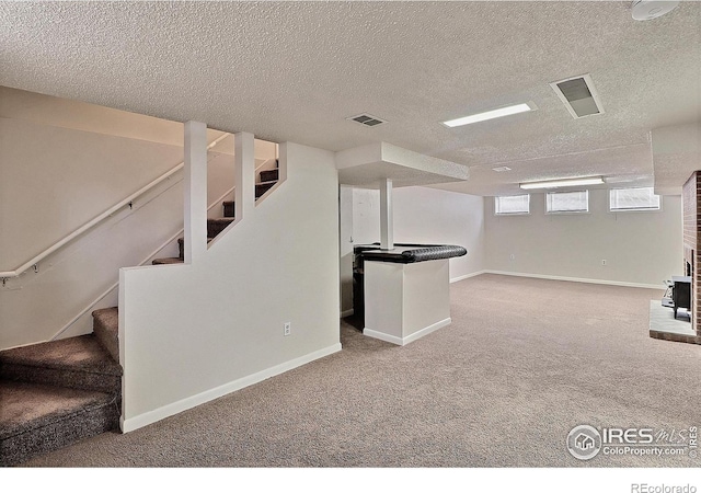 basement with carpet and a textured ceiling