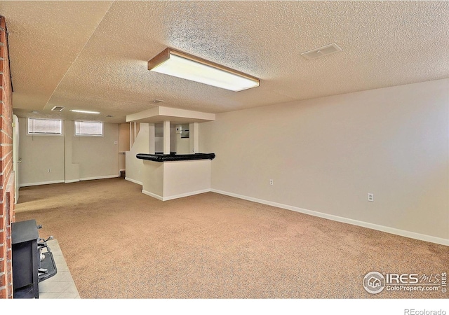 interior space with light colored carpet and a textured ceiling