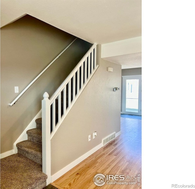 560 S 9th St, Berthoud, CO 80513 - staircase featuring baseboards and wood finished floors