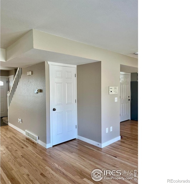 560 S 9th St, Berthoud, CO 80513 - spare room featuring light wood-type flooring, baseboards, and stairway