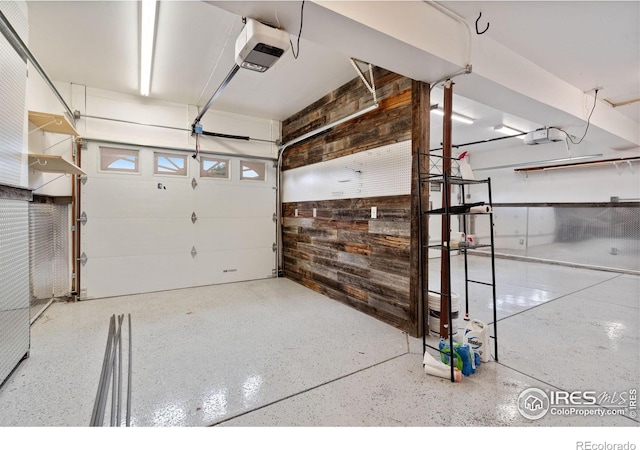 560 S 9th St, Berthoud, CO 80513 - garage featuring wooden walls and a garage door opener