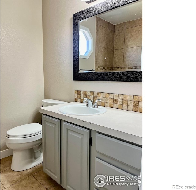 560 S 9th St, Berthoud, CO 80513 - bathroom featuring vanity, tile patterned floors, toilet, a textured wall, and tasteful backsplash