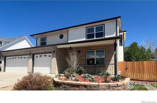 560 S 9th St, Berthoud, CO 80513 - traditional-style home featuring fence, brick siding, concrete driveway, a garage, and a porch