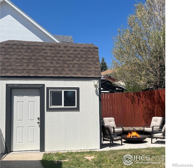 560 S 9th St, Berthoud, CO 80513 - view of shed featuring an outdoor fire pit and fence