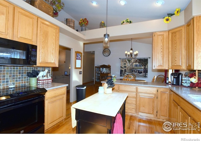 2707 Sedona Hills Dr, Loveland, CO 80537 - kitchen featuring tasteful backsplash, hanging light fixtures, black appliances, and light brown cabinetry