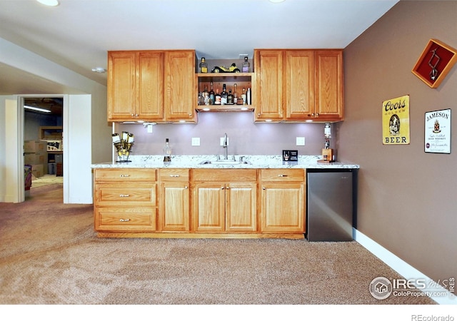 2707 Sedona Hills Dr, Loveland, CO 80537 - kitchen featuring light colored carpet, stainless steel fridge, light stone countertops, and sink
