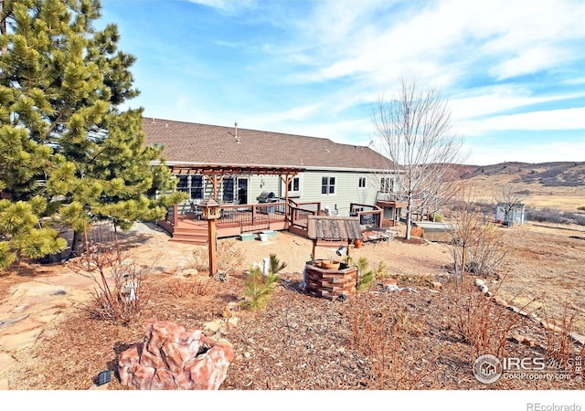2707 Sedona Hills Dr, Loveland, CO 80537 - back of property featuring a deck with mountain view and a pergola