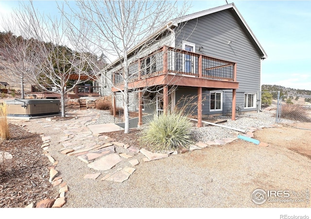 2707 Sedona Hills Dr, Loveland, CO 80537 - back of house with a wooden deck and a hot tub