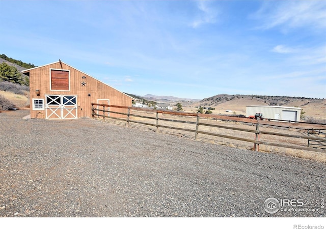 2707 Sedona Hills Dr, Loveland, CO 80537 - view of yard featuring an outbuilding, a mountain view, and a rural view