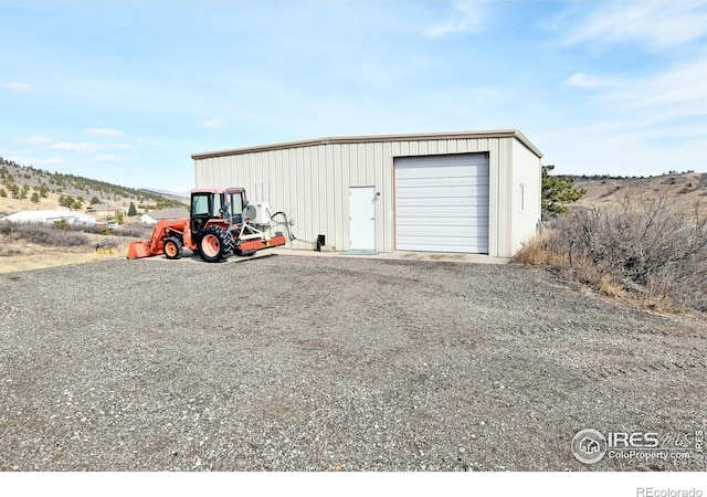 2707 Sedona Hills Dr, Loveland, CO 80537 - view of outbuilding with a mountain view and a garage