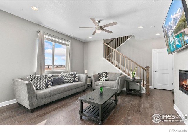 living room with ceiling fan and dark hardwood / wood-style flooring