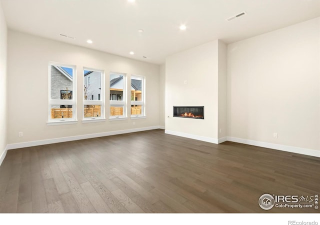 unfurnished living room featuring dark hardwood / wood-style floors