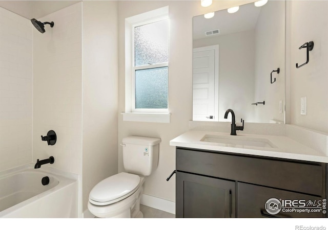 full bathroom featuring vanity, toilet, and tiled shower / bath