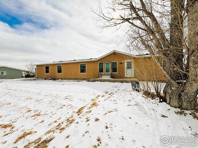 view of snow covered house