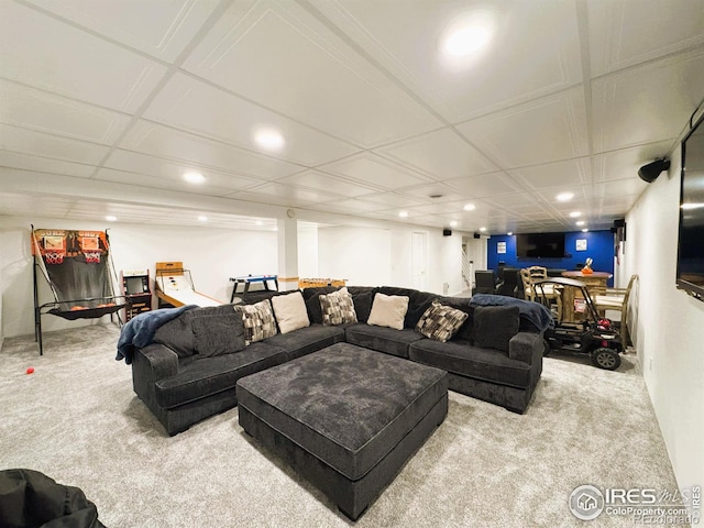 carpeted living room with a drop ceiling