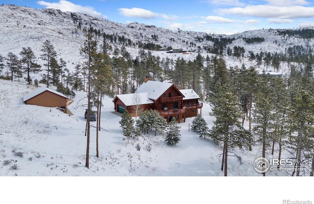 snowy aerial view with a mountain view