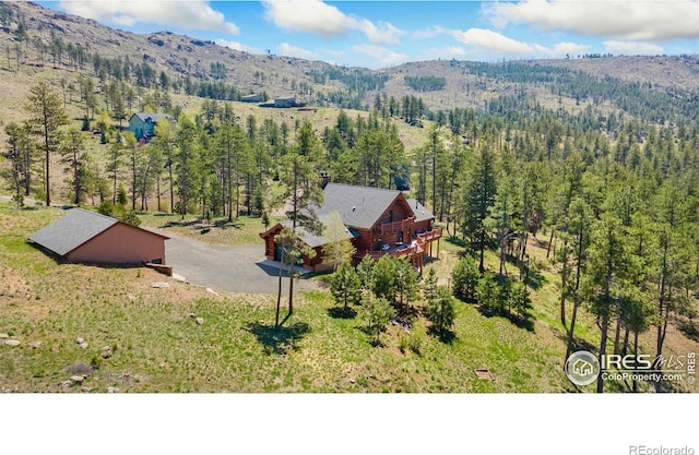 117 Crocus Dr, Bellvue, CO 80512 - view of subject property featuring a mountain backdrop and a heavily wooded area